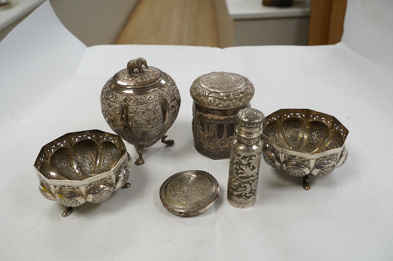 A pair of Indian pierced cusped white metal bowls, diameter 84mm, three other Indian white metal canisters and a Middle Eastern pill box. Condition - fair